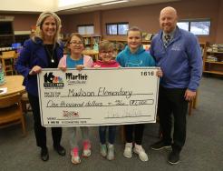 WNDU's Tricia Sloma (left) presenting their check with Madison Elementary School Principal Kevin McMillen (right) and Madison Students
