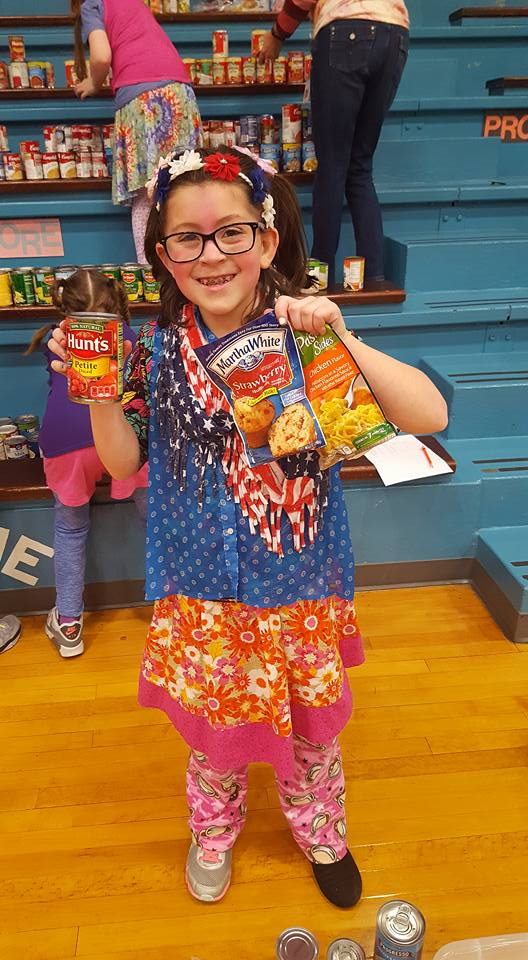 Student showing food collected at Madison