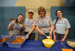 people serve food at fish fry