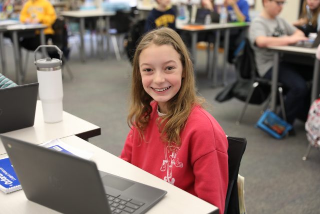 female student sitting in front of a laptop