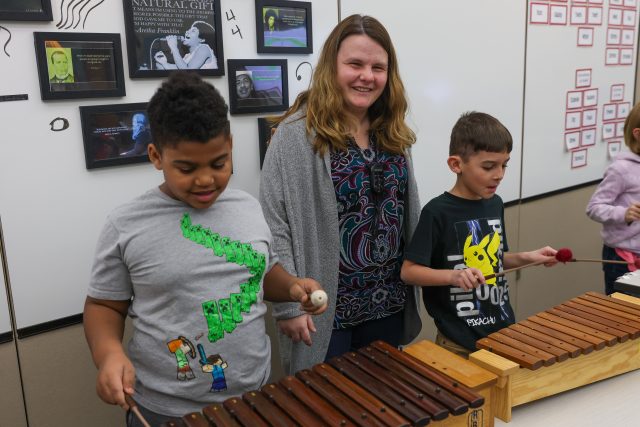 teacher with students playing xylophone