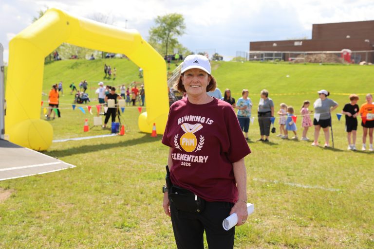 woman in maroon t-shirt that reads Running is Elementary